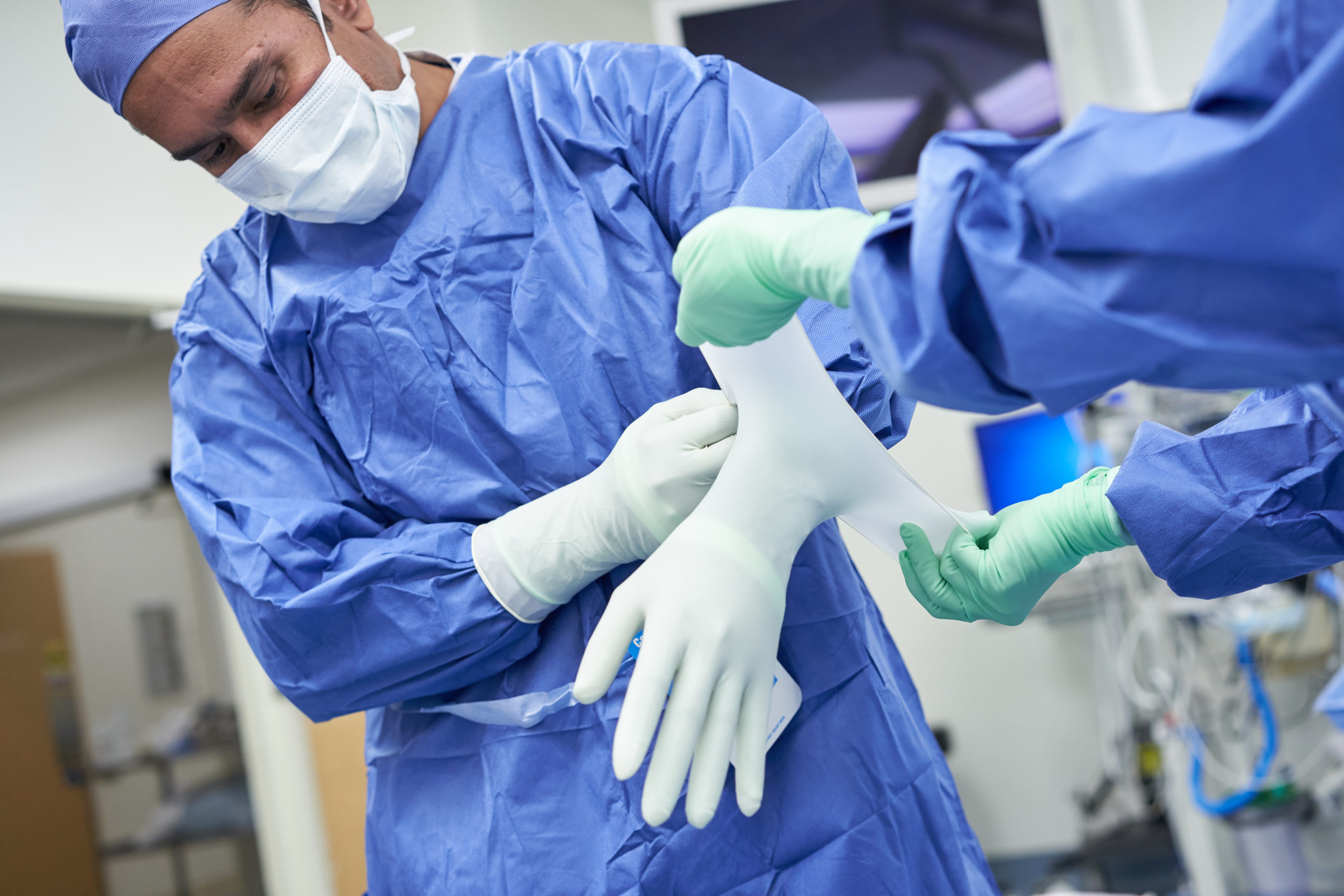 Medical staff put on PPE in hospital setting