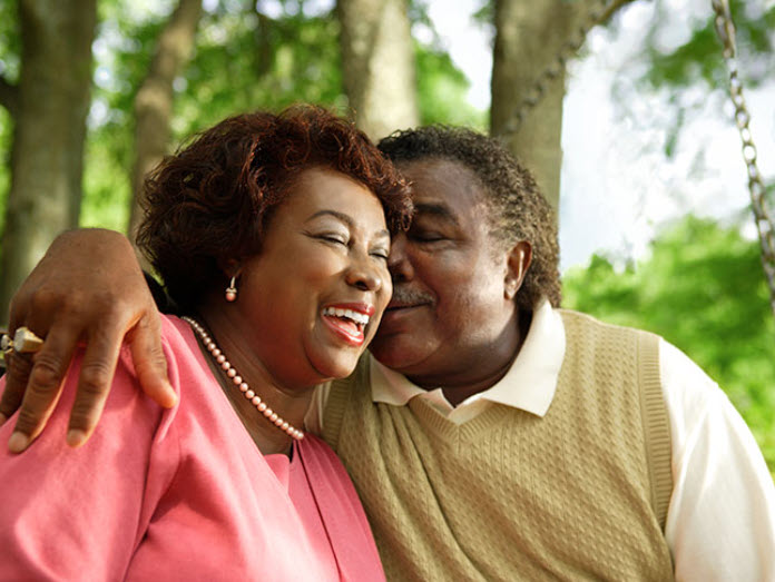 Black man and woman sitting together and embracing