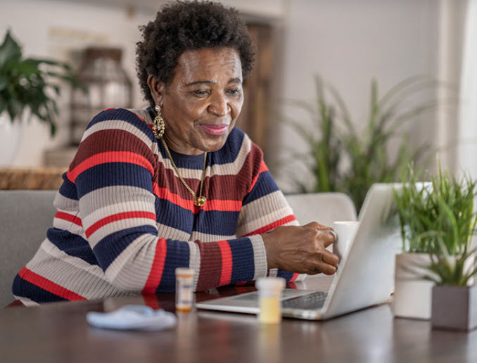 Woman takes part in video visit with laptop