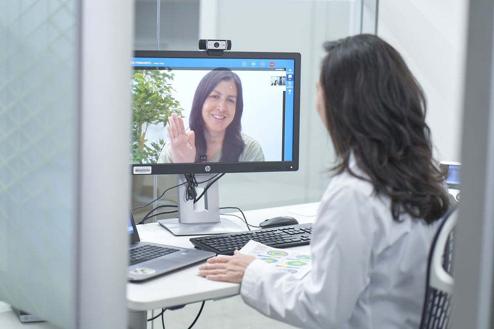Female doctor speaking with female patient during telehealth visit.