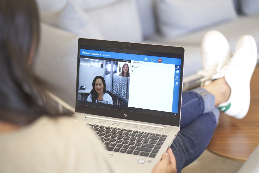 Patient on laptop for e-visit with clinician