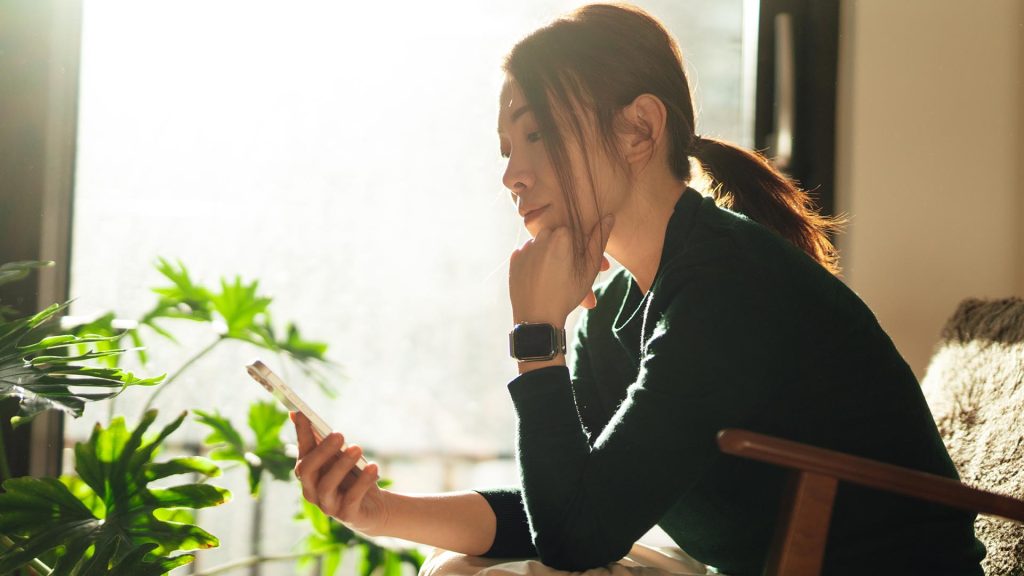 Woman using mobile device at home