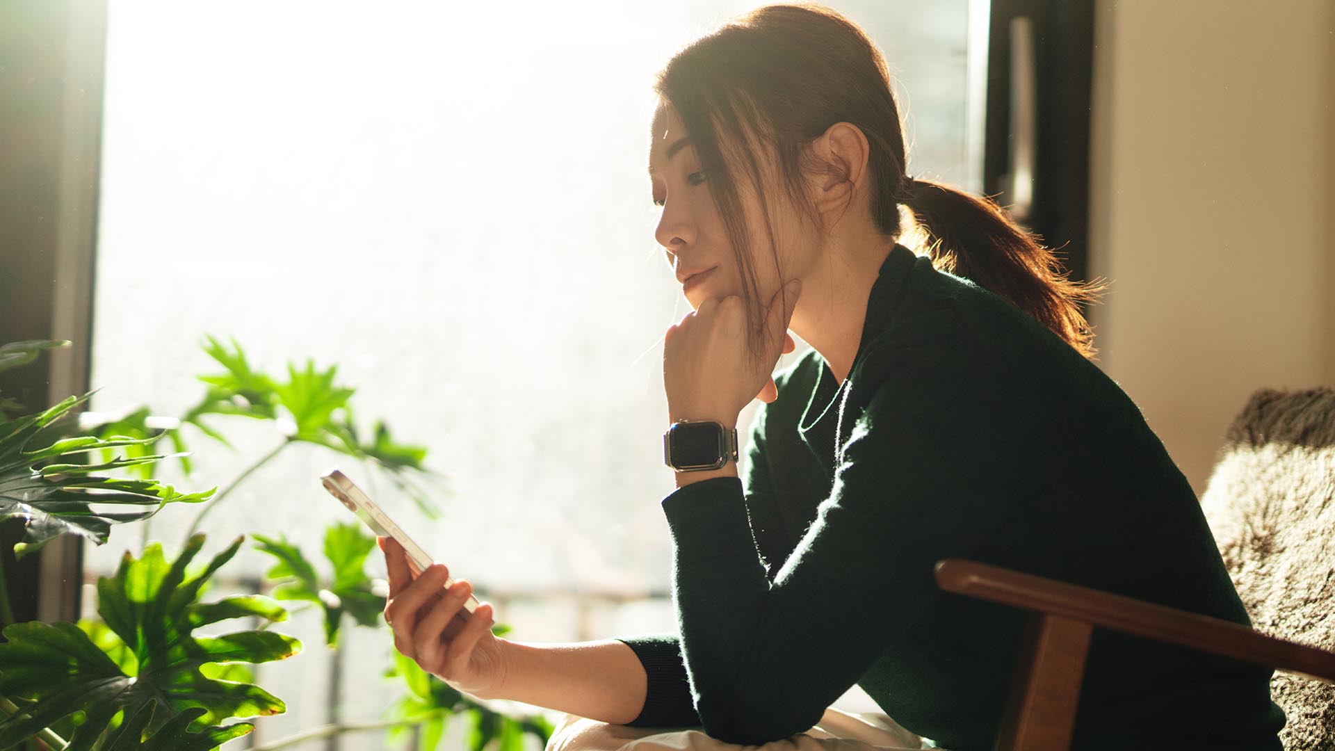 Woman using mobile device at home